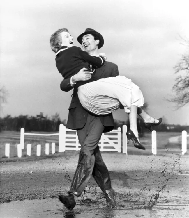 5.Man Carrying across puddle Norman Parkinson foto