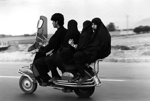 13. Abbas Attar IRAN. Shahr Rey. Young man three veiled girls in a four seater motorbike 1997